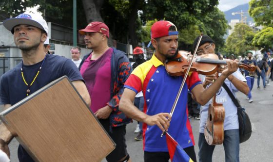Wuilly Arteaga plays his violin during an anti-government march in Venezuela. (AP Photo/Fernando Llano)
