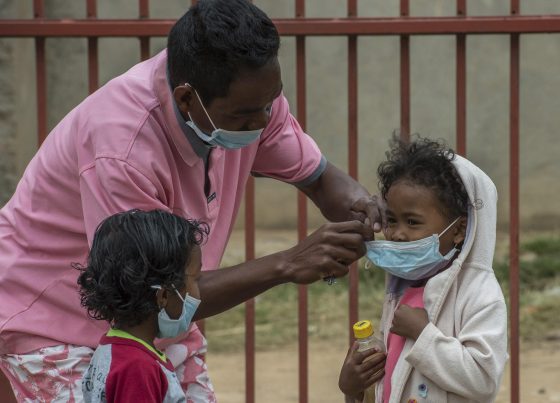 Face masks are placed on children in Antananarivo, Madagascar (AP Photo/Alexander JOE)
