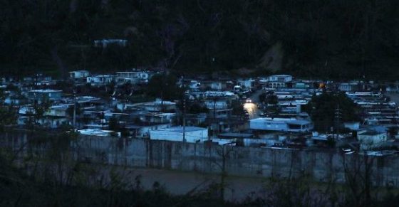 A lone car provides the only source of light in devastated Puerto Rico city of Utuado.